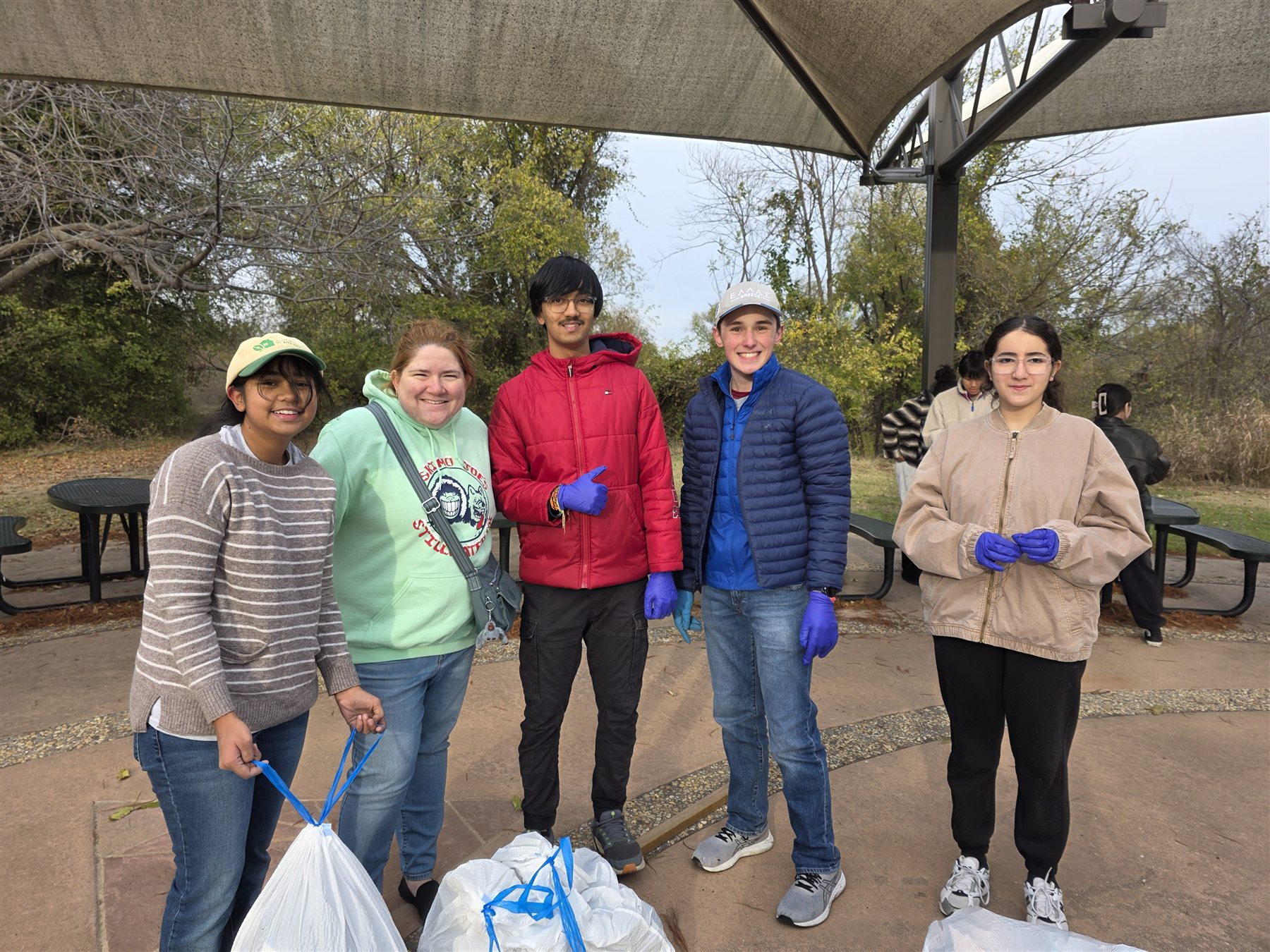 A group of cleanup volunteers with collected bags