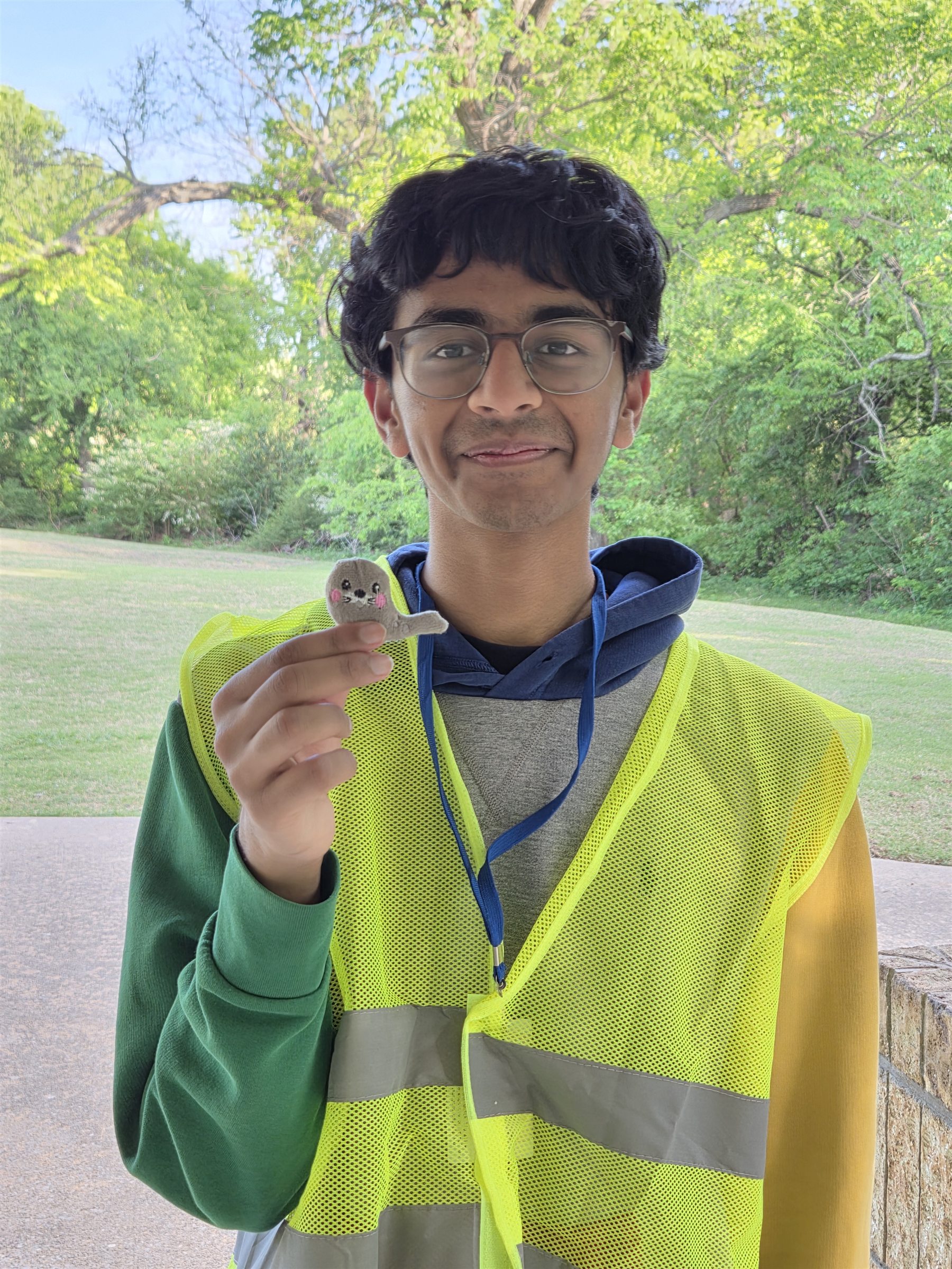 A student volunteer showing a small item collected during the cleanup